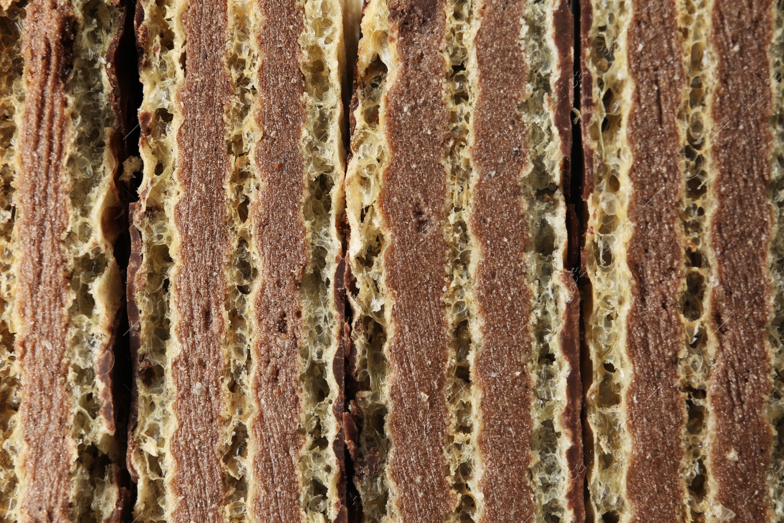 Photo of Closeup view of tasty wafer sticks as background. Sweet food