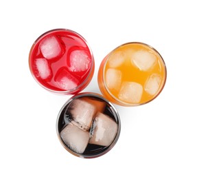 Photo of Glasses of different refreshing soda water with ice cubes on white background, top view