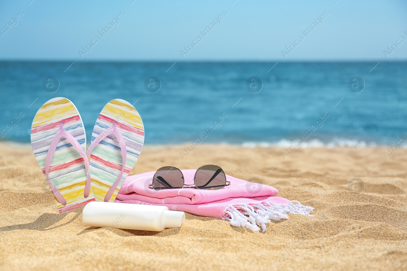 Photo of Set of different beach objects on sand near sea. Space for text