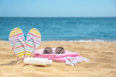 Set of different beach objects on sand near sea. Space for text