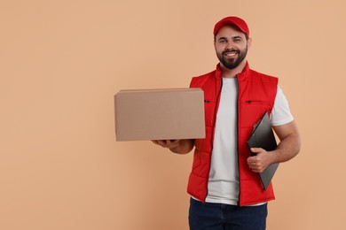 Photo of Happy young courier with parcel and clipboard on light brown background. Space for text