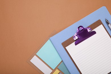 To do notes, stationery and planner on brown background, flat lay. Space for text