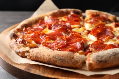 Photo of Tasty hot pepperoni pizza on table, closeup