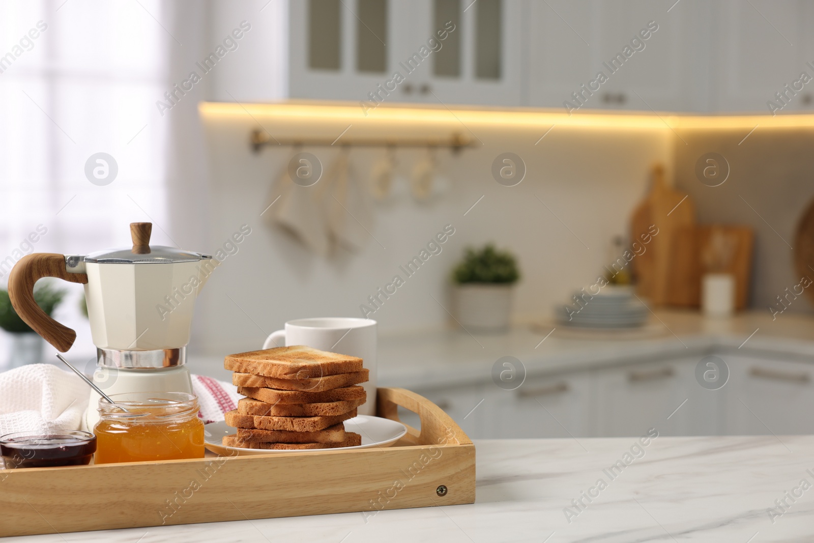 Photo of Breakfast served in kitchen. Tray with toasts, honey, jam and coffee on white table. Space for text