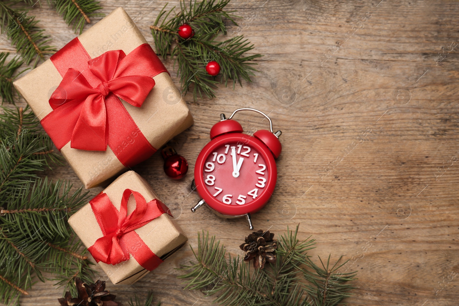 Photo of Flat lay composition with Christmas gifts and alarm clock on wooden table, space for text. Boxing day