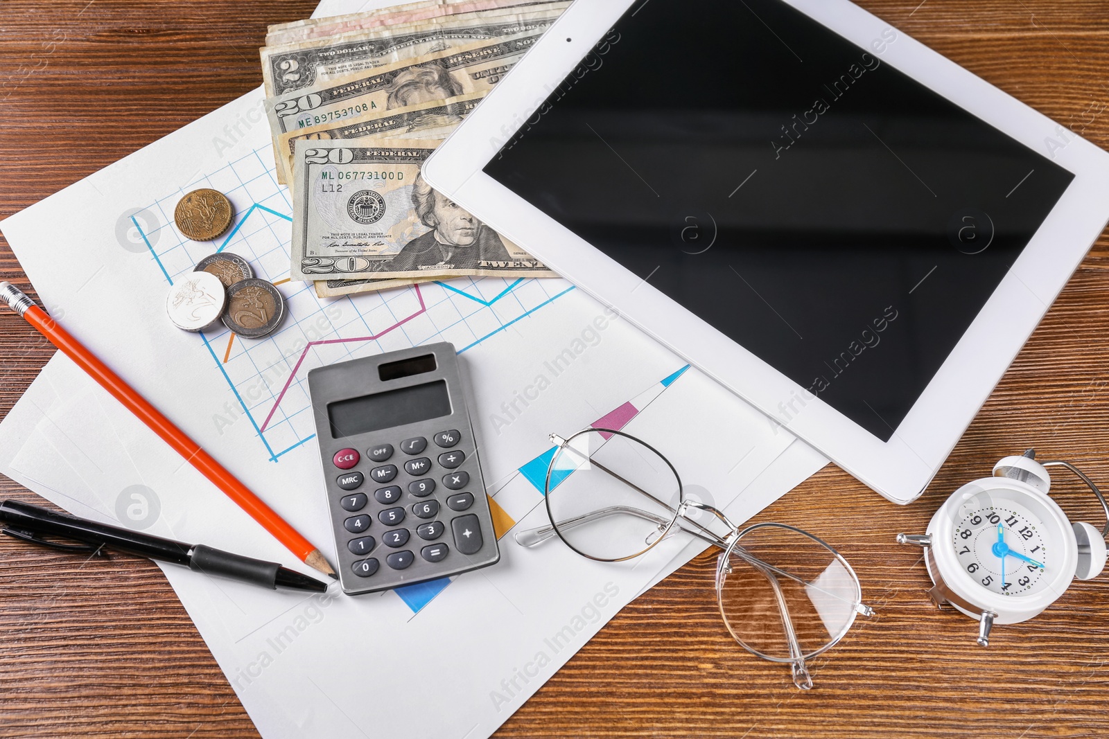 Photo of Composition with tablet, calculator and money on wooden table. Pension planning