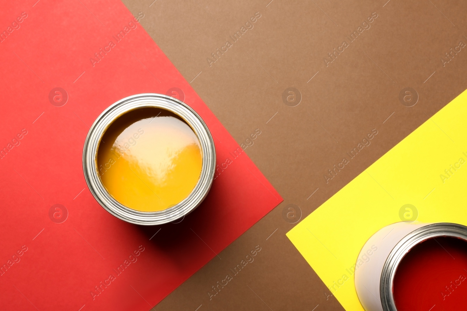 Photo of Flat lay composition with paint cans and space for text on color background