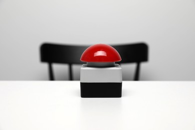 Photo of Red button of nuclear weapon on white table. War concept
