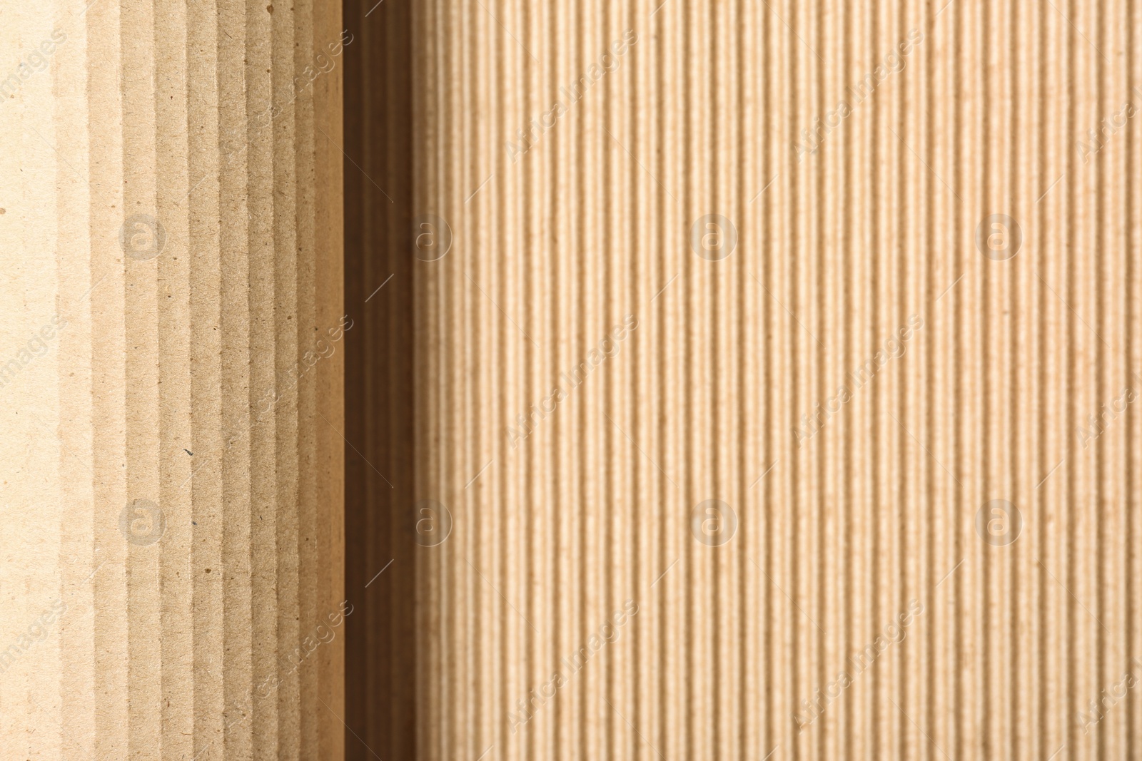 Photo of Corrugated cardboard as background, top view with space for text. Recyclable material