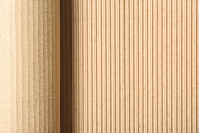 Photo of Corrugated cardboard as background, top view with space for text. Recyclable material