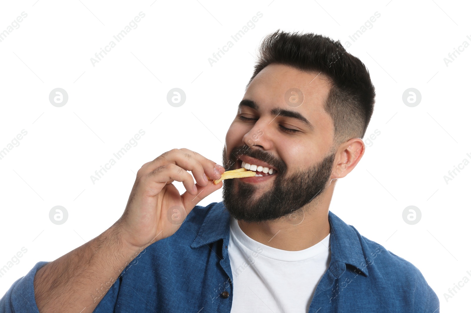 Photo of Young man eating French fries on white background