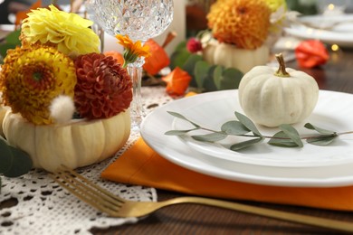 Photo of Beautiful autumn table setting. Plates, cutlery, glasses and floral decor, closeup