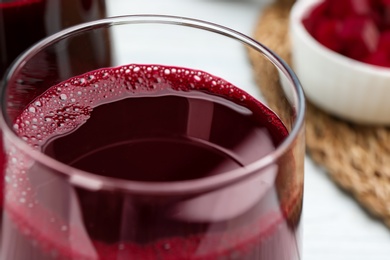 Photo of Fresh beet juice in glass on table, closeup