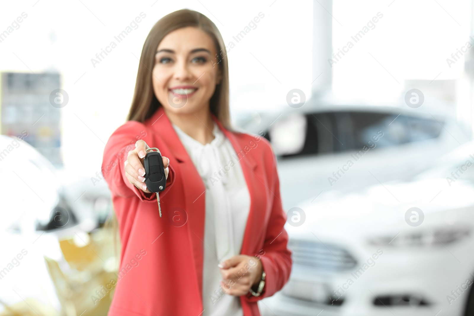 Photo of Young woman holding car key in salon