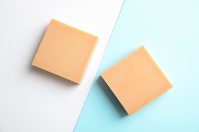 Hand made soap bars on color background, top view