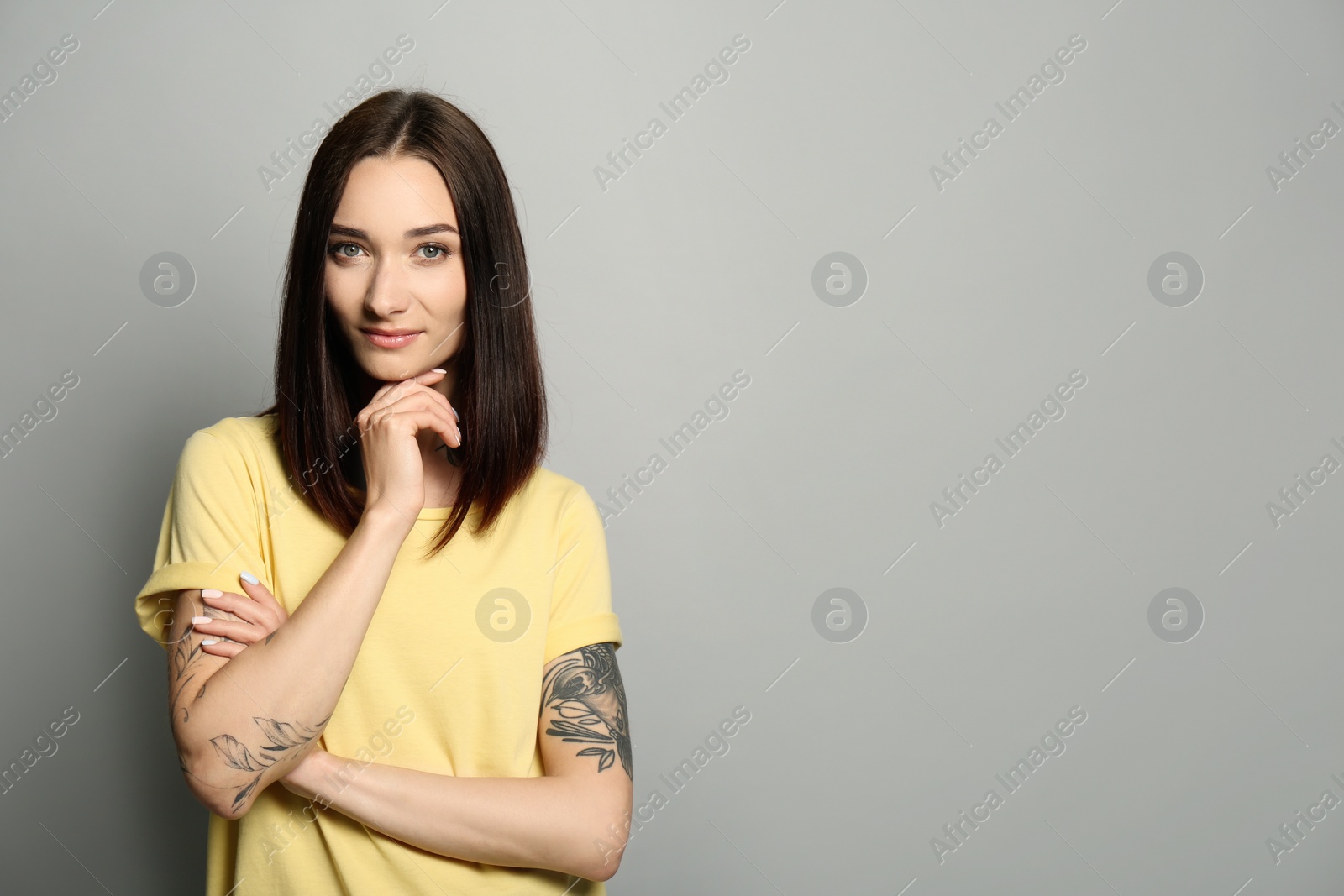 Photo of Portrait of pretty young woman with gorgeous chestnut hair on light grey background, space for text