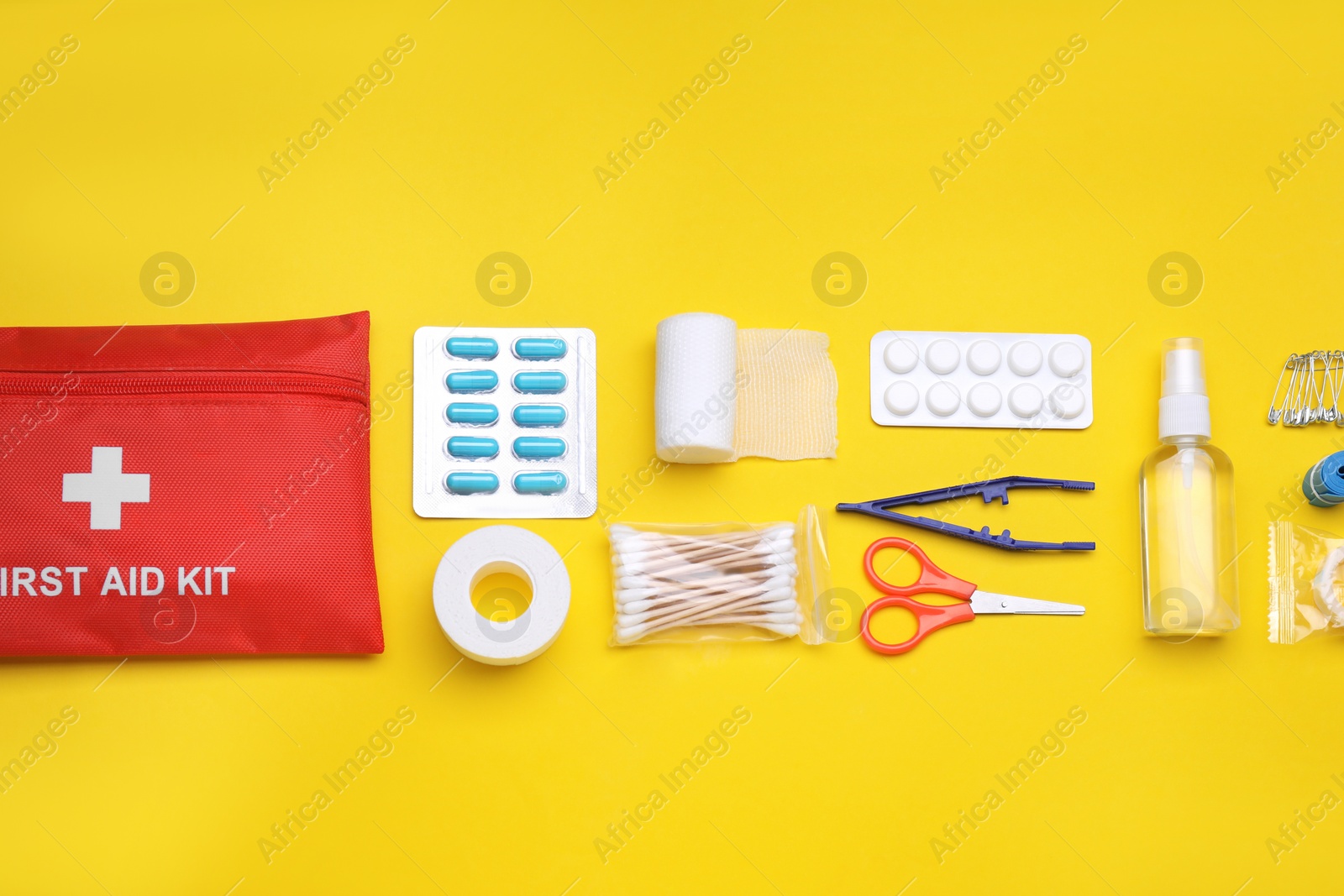 Photo of Flat lay composition with first aid kit on yellow background