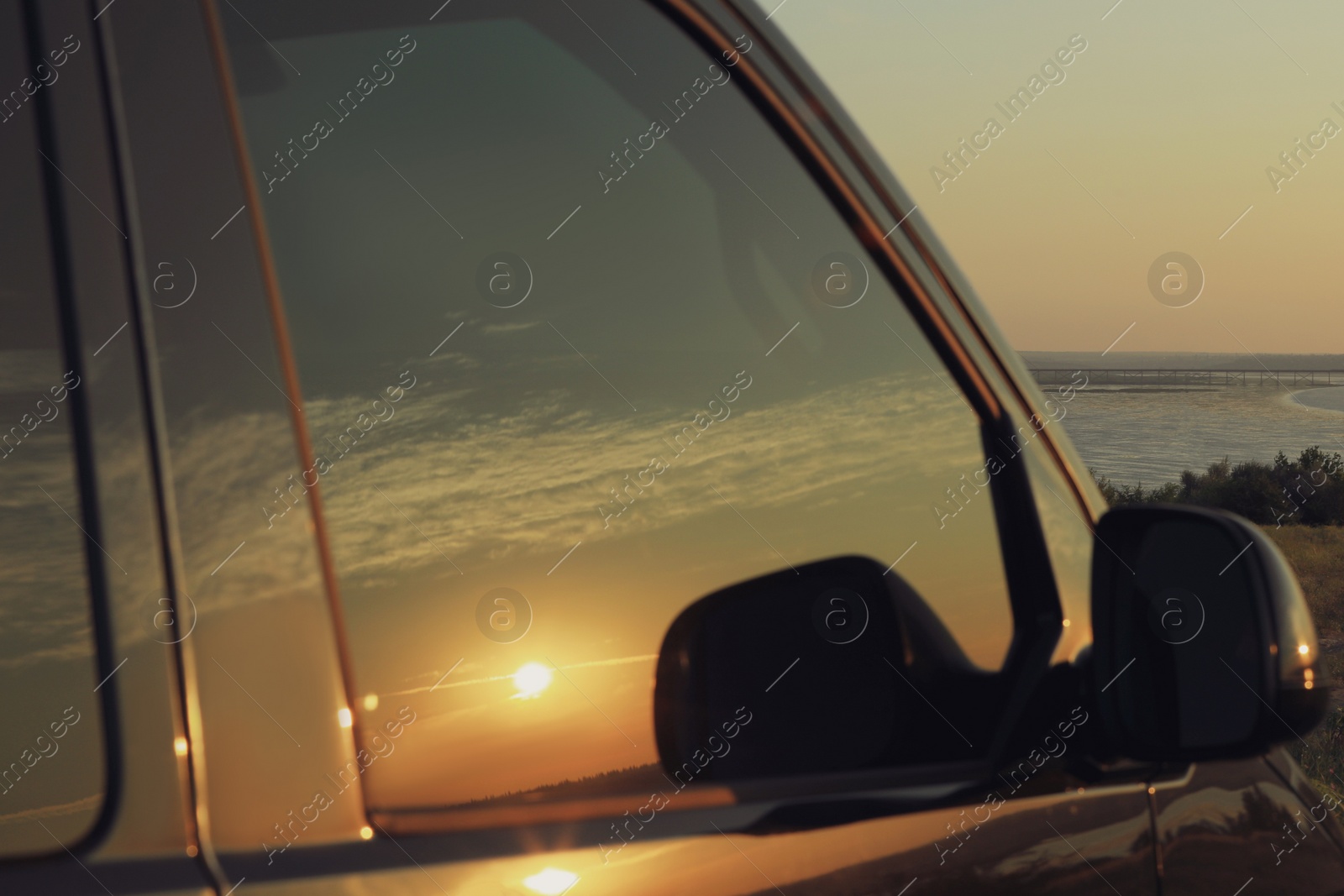 Photo of Reflection of beautiful cloudy sky at sunrise in car window