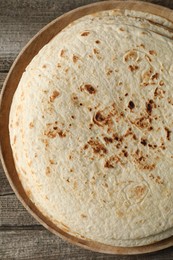 Stack of tasty homemade tortillas on wooden table, top view