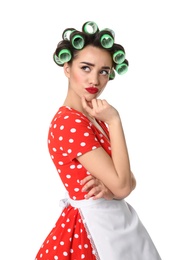 Photo of Funny young housewife with hair rollers on white background