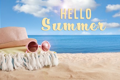 Image of Hello Summer. Hat, towel and sunglasses on sand near sea
