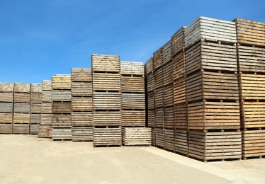 Photo of Pile of empty wooden crates outdoors on sunny day