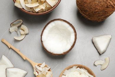 Photo of Flat lay composition with tasty coconut chips on grey table