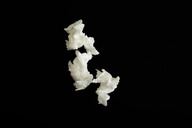 Photo of Used paper tissues on black background, flat lay