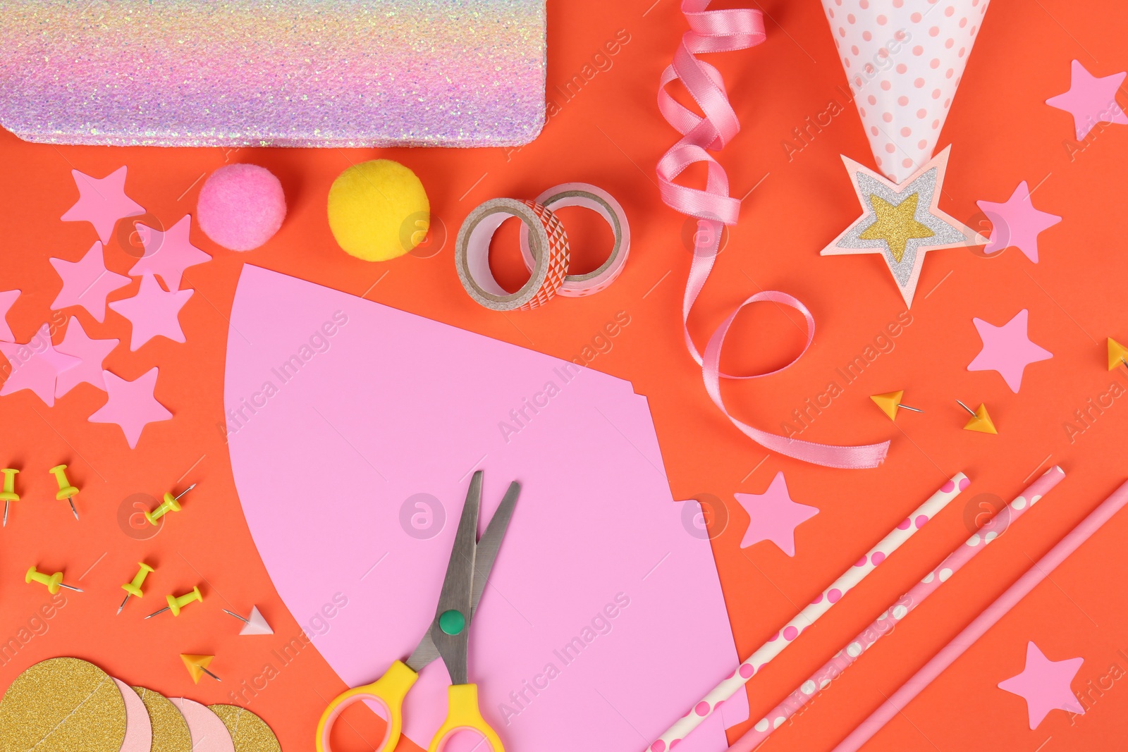 Photo of Different stationery and materials for creation of colorful party hats on orange background, flat lay. Handmade decorations