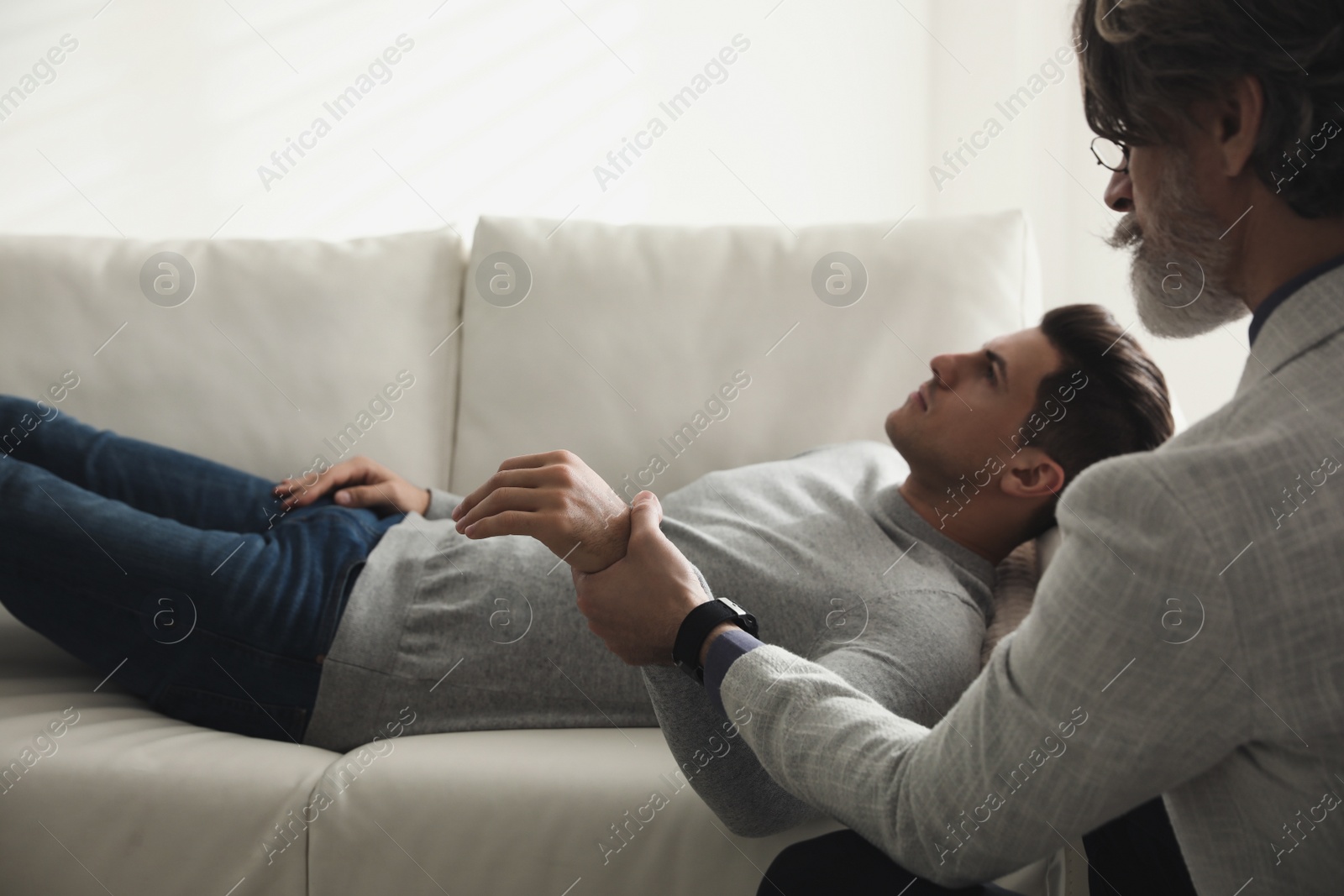 Photo of Psychotherapist and patient in office. Hypnotherapy session