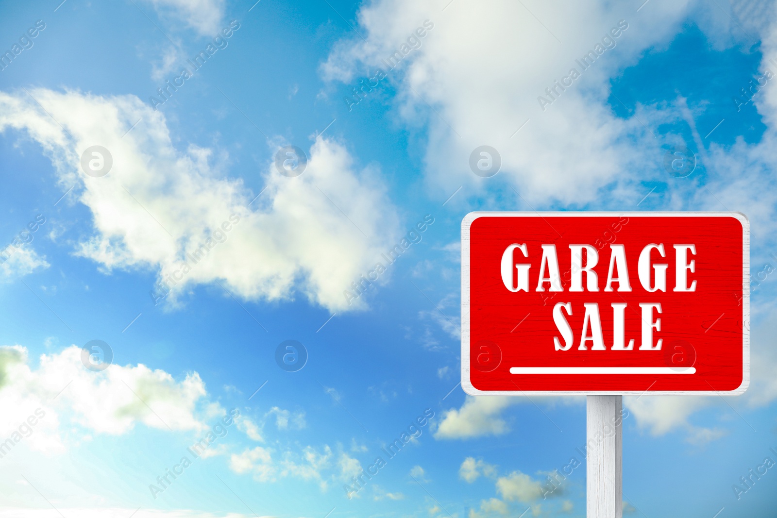 Image of Sign with phrase GARAGE SALE and blue sky 