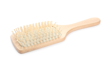 Photo of New wooden hair brush isolated on white