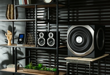 Modern audio speaker system on shelving indoors