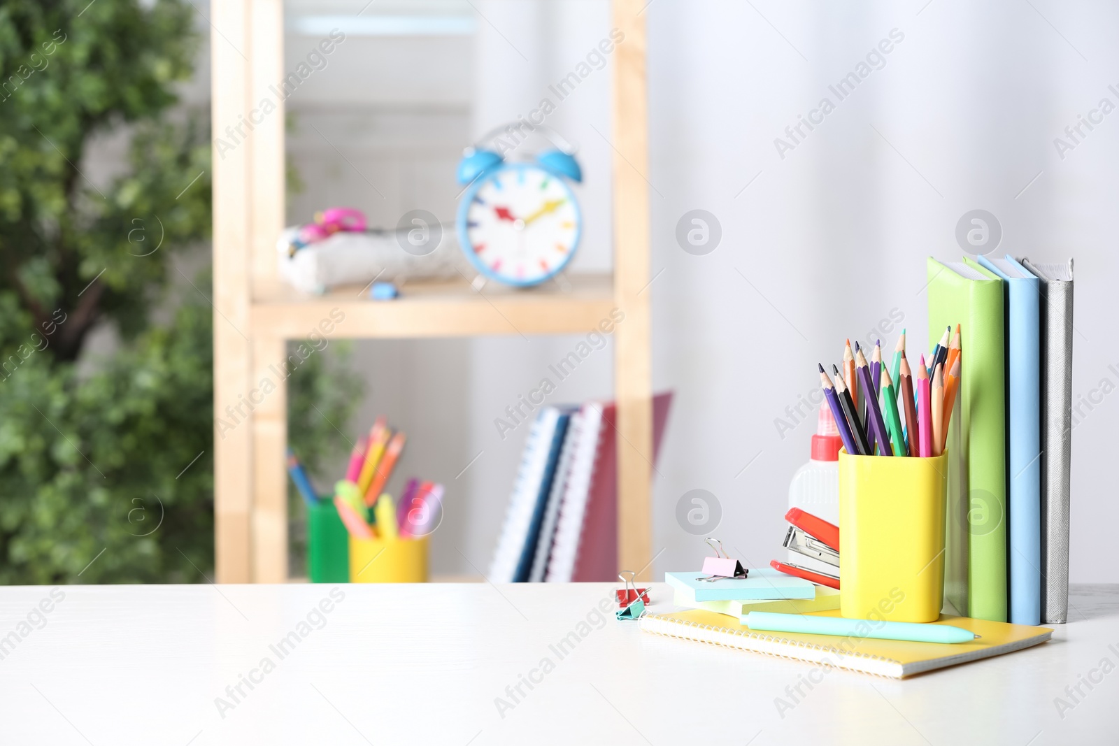 Photo of Different school stationery on white table indoors. Space for text