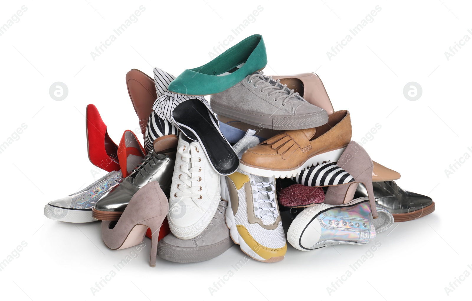 Photo of Pile of female shoes on white background