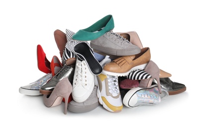 Photo of Pile of female shoes on white background