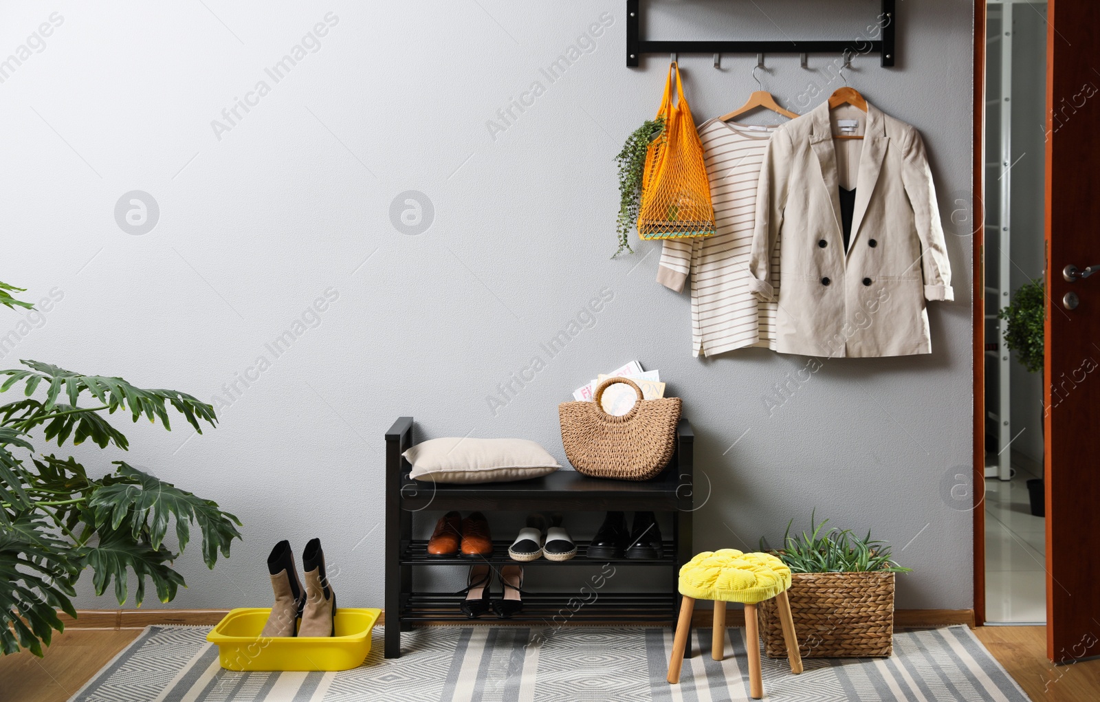 Photo of Hallway interior with stylish furniture, clothes and accessories