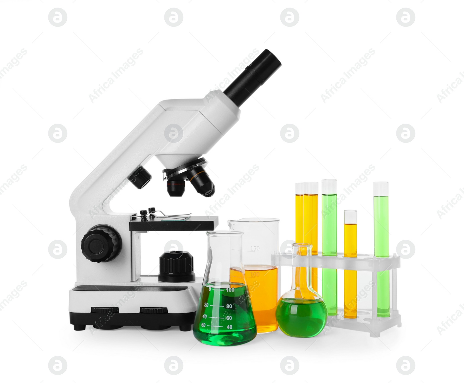 Photo of Laboratory glassware with colorful liquids and microscope isolated on white