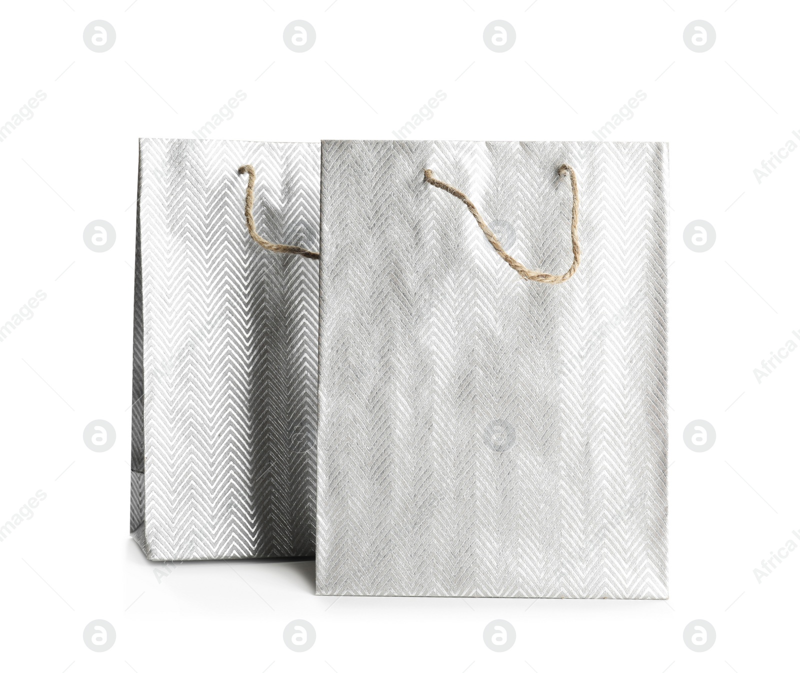 Photo of Silver paper shopping bags isolated on white. Space for design