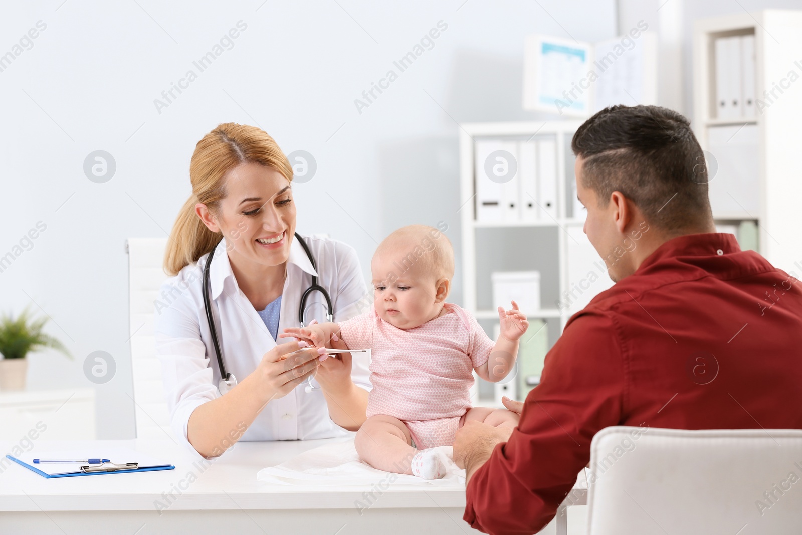 Photo of Man with his baby visiting children's doctor in hospital