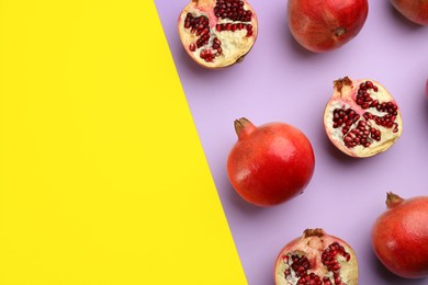 Flat lay composition with ripe pomegranates on color background. Space for text