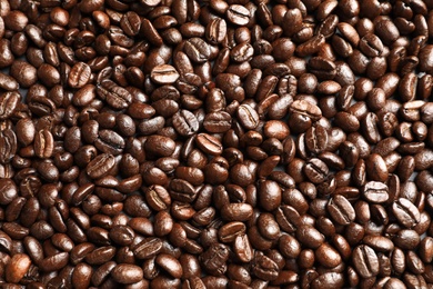 Roasted coffee beans as background, top view