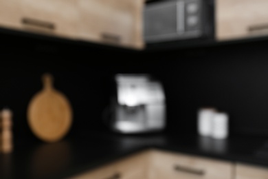 Blurred view of kitchen interior with modern furniture