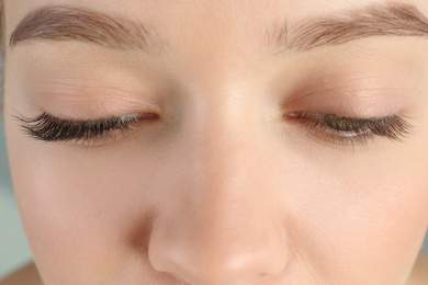 Photo of Young woman with beautiful eyelashes, closeup. Before and after extension procedure
