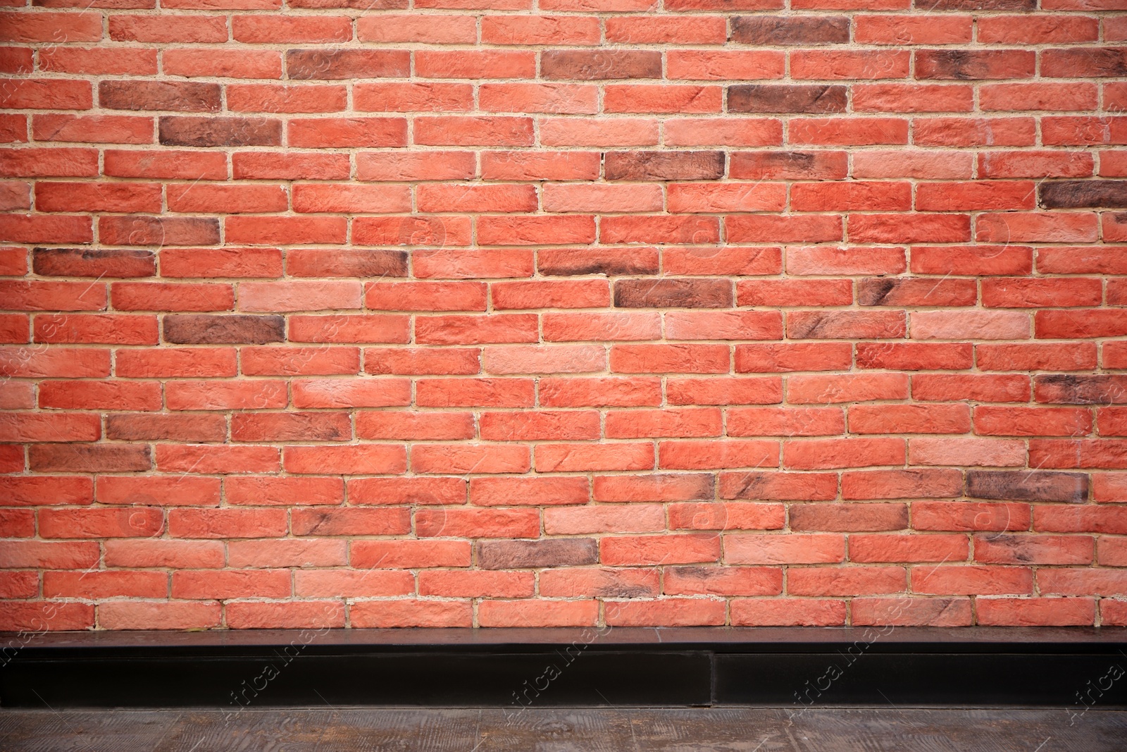 Photo of View on red brick wall and wooden floor