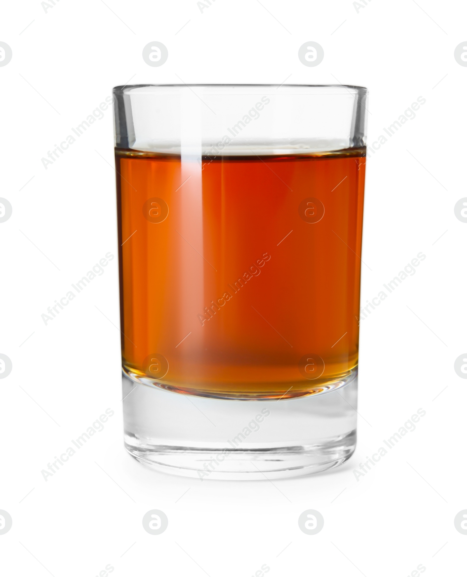 Photo of Shot glass with tasty amaretto liqueur isolated on white