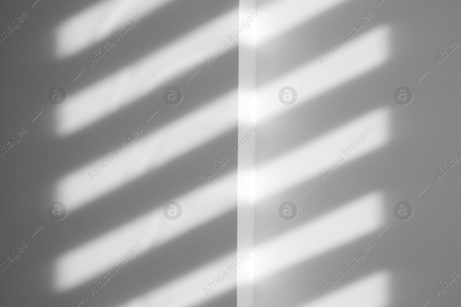 Photo of Lines made of light and shadows on white wall