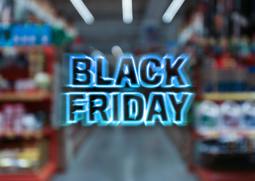 Blurred view of shopping mall interior. Black Friday Sale