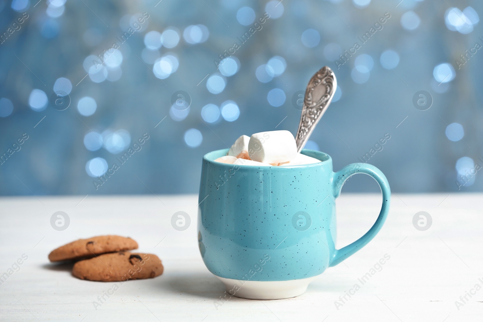 Photo of Cup with delicious hot cocoa drink with marshmallows on table