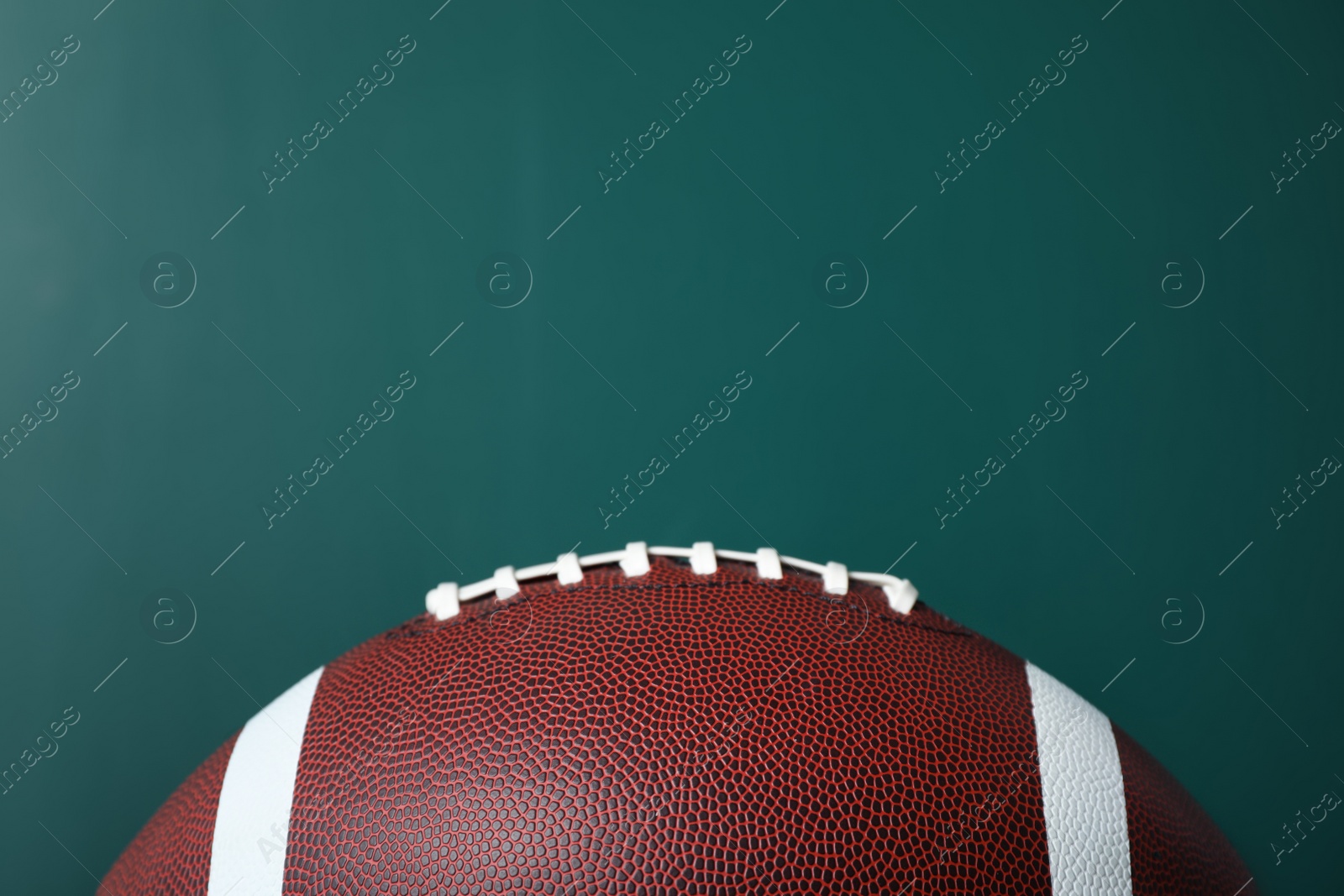 Photo of New leather American football on chalkboard, closeup